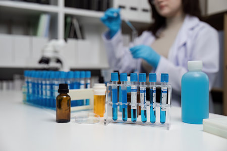 Modern Scientific Laboratory with Test Tubes and Researcher Conducting Experiments in a Controlled...