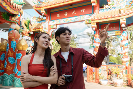 Celebrating new year a joyful couple at a chinese festival colorful streets outdoor captured in daylight cultural experienceの写真素材