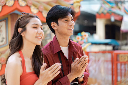 Joyful Traveler Celebrating Chinese New Year at a Vibrant Temple with Traditional Decorationsの写真素材