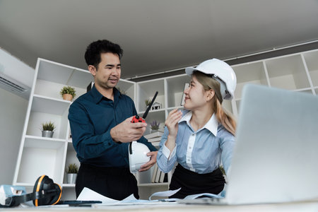 Engineer and architect collaborate on blueprint project in modern office setting creative vision and teamworkの写真素材