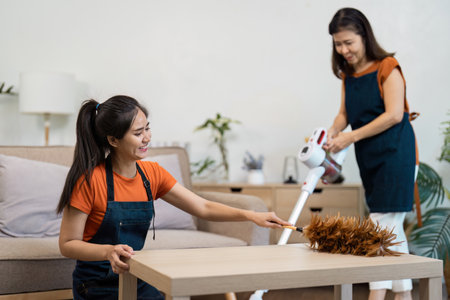 Professional Housekeeper Performing Cleaning Tasks in a Modern Home Environment with Vacuum and...