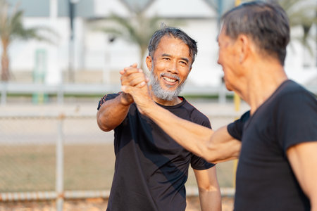 Wellness and friendship among seniors embracing healthy living through connection.の写真素材