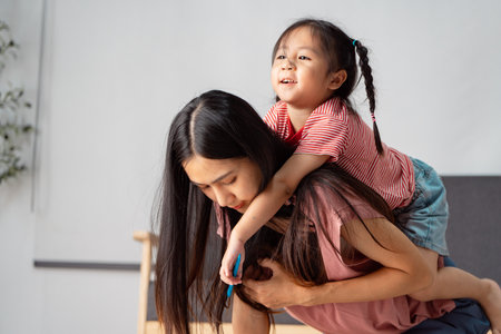 Playful learning moments with a mother and child sharing joy and creativityの写真素材