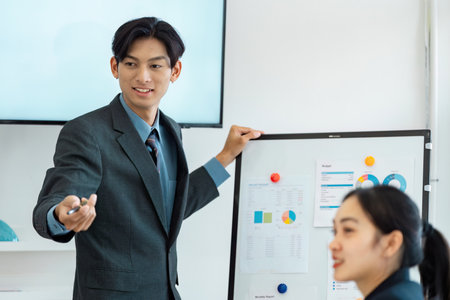 Engaging business presentation with a young professional showcasing budget insights.の写真素材