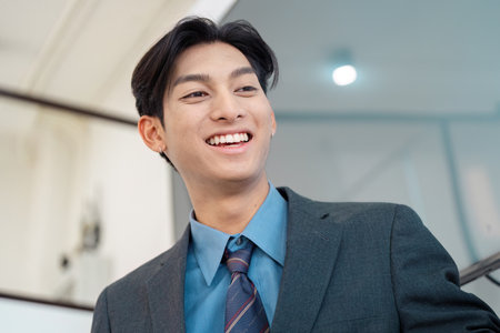 Smiling businessman in a suit, showcasing professionalism and confidence.の写真素材