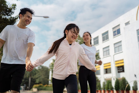 Family exercising together, father and mother encouraging their daughter during a joyful outdoor run