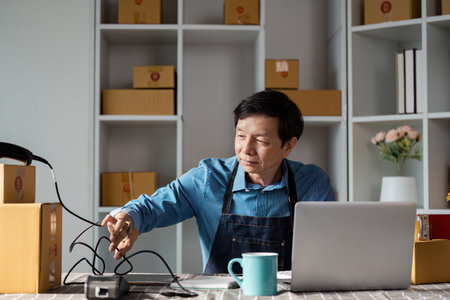 E-commerce entrepreneur managing online sales from home office, focusing on business operations and customer service.の写真素材