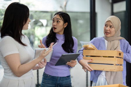 Women discussing sustainable donation practices in a community settingの写真素材