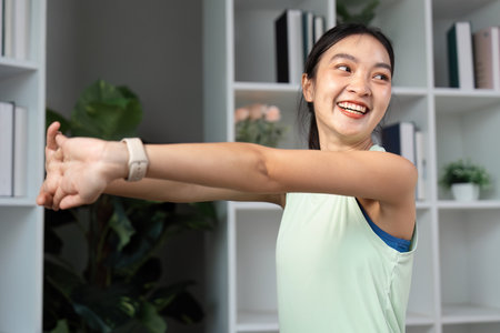 Smiling woman stretching her arms, promoting fitness and wellness at home.