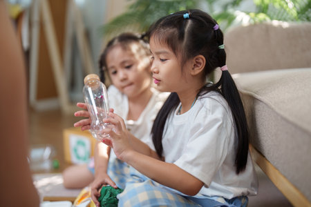 Recycling and Creativity. Children engaging in recycling to create new art projects from waste materials.の写真素材