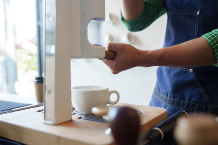 Sustainable Innovation and Coffee Preparation. A barista uses modern equipment to craft coffee, focusing on sustainable methods.の写真素材