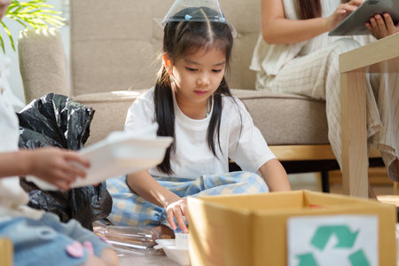 Sustainable Crafts and Environmental Education. Children learning to recycle materials creatively while engaging in eco-friendly crafts.の写真素材