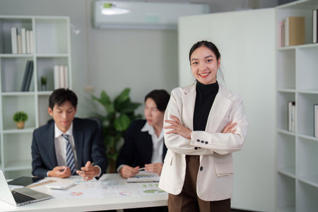 Leadership and Team Dynamics. A confident professional stands out in a business discussion.