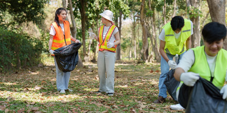 Environmental Awareness and Action. Volunteers actively participating in a park cleanup to promote sustainability.の写真素材