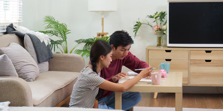 Collaborative Planning and Cohabitation. A couple discussing finances over coffee, focused on future investments.の写真素材