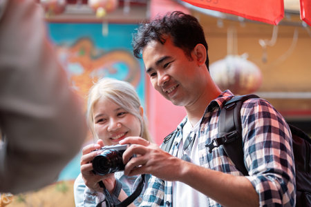 Camera Fun and Exploration. A couple reviewing photos captured during their travel adventure.の写真素材