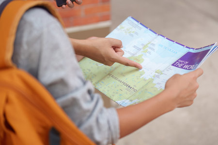 Travel and Exploration. A traveler studying a map, ready for their next adventure.の写真素材