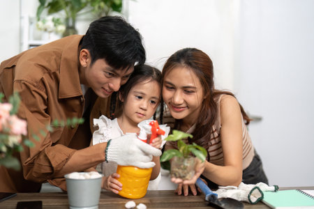 Family Bonding and Sustainability. A family engages in a planting activity, nurturing a green lifestyle together.の写真素材