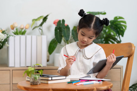 Creativity and Focus. A girl studies with her tools ready, demonstrating a commitment to learning.