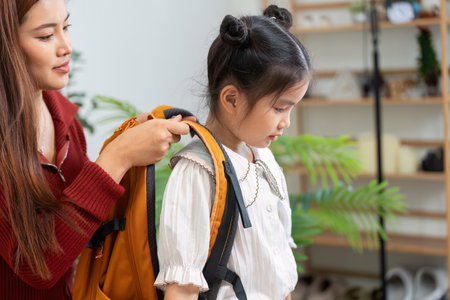 Back to School and Parental Support. A mother assisting her daughter as she prepares for school.の写真素材