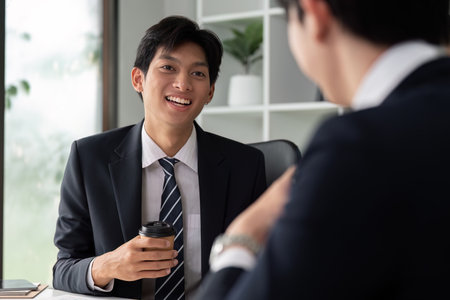 Business Discussion and Relationship Building. Two professionals engage in a conversation to foster partnerships and explore growth opportunities.の写真素材