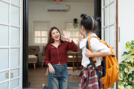 Back to School and Family Bonding. A child prepares for school with her mothers support and encouragement.の写真素材