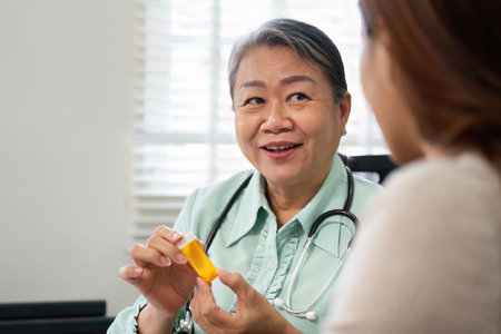 Elderly Doctor and Patient Consultation. An experienced physician engaging with a patient, showcasing a supportive healthcare environment.の写真素材