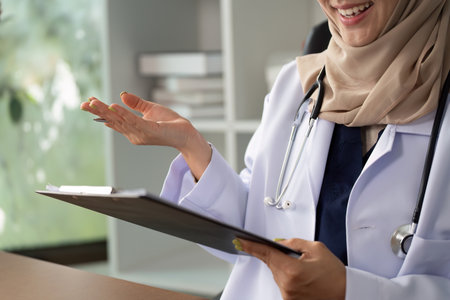 Telemedicine and Patient Engagement. A telehealth professional consulting with a patient through video call, showcasing medical expertise.の写真素材