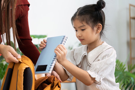 Back to School Excitement and Preparation. A girl organizing her school supplies with care and anticipation.の写真素材