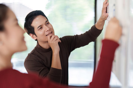 Ideation and User-Centric Design. A designer pondering ideas for a user interface while collaborating with a team member.の写真素材