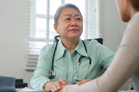 Understanding Patient Needs. A doctor attentively listens to a patient, focusing on their health concerns during consultation.の写真素材