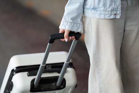 Travel Essentials. Close-up of a travel bag handled with care, indicating readiness for a journey.の写真素材