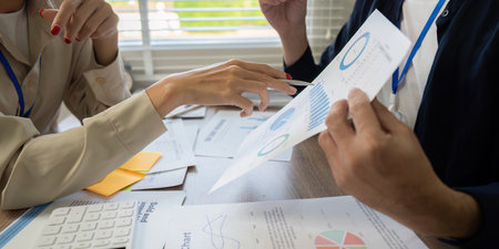 Visual Data and Strategy Session. A businesswoman uses charts to illustrate important project...