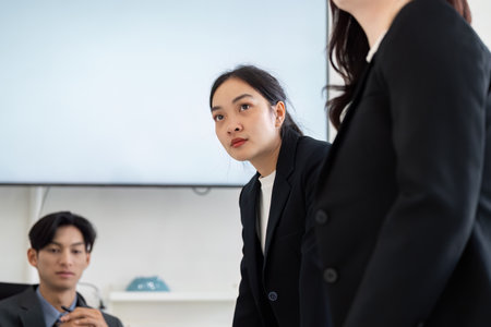 Leadership and Focused Discussion. A businesswoman attentively listening during a strategy meeting.