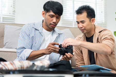 Travel Planning and Photography. A couple reviewing travel photos together, excited for their upcoming adventure.の写真素材