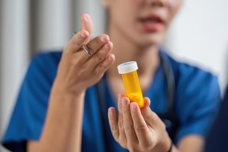 A healthcare professional discusses medication during a team consultation.の写真素材