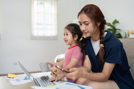 Quality Time and Interaction. A mother and daughter enjoying a productive moment together with technology.の写真素材