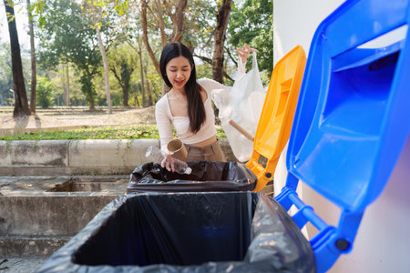 Waste Management and Environmental Stewardship. A woman happily disposing of various recyclables,...