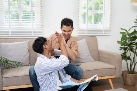 Planning and Fun. A couple playfully interacting while reviewing their travel plans.