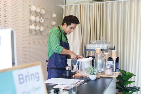Sustainability and Coffee Crafting. A barista focused on making coffee in an eco-conscious cafe.