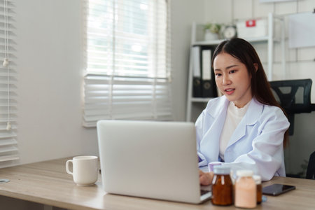 Telehealth and Online Consultation. A healthcare professional engages with patients through digital platforms.の写真素材