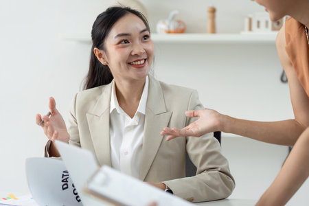 Business Discussion. Smiling professional woman engaging in conversation.の写真素材