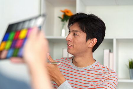 Creativity in Action. A designer analyses colors during a brainstorming session in the office.の写真素材