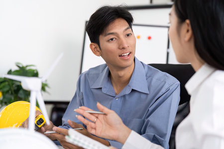 Sustainability and Engineering. Engaged engineers brainstorming sustainable solutions using design models.の写真素材