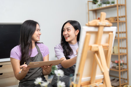 LGBTQ couple sharing creativity while painting together at homeの写真素材