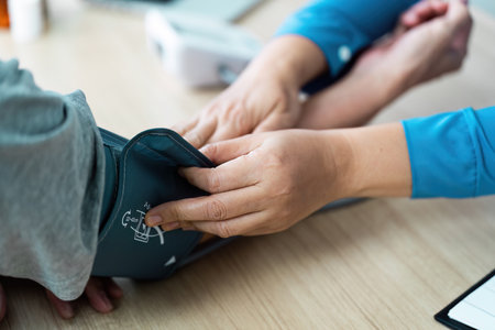 Doctor measuring blood pressure during patient consultation in clinic