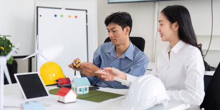 Sustainability and Engineering. Two engineers discussing eco-friendly design solutions with models...