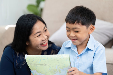 Planning and Travel. A mother and son explore a map together, excited about their next destination.の写真素材
