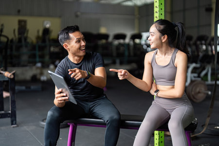 Personal Trainer and Client Engaging in Fitness Discussion
