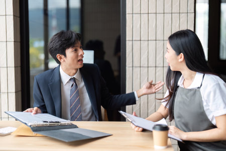 Dynamic Business Discussion. A professional engaging in a lively conversation with a colleague during a meeting.の写真素材